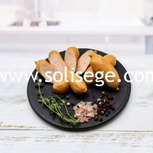solisege chicken cocktail sausages cooked on a black round plate.
